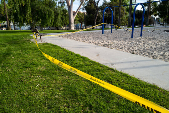 A deserted playground in Los Angeles closed due to the pandemic with yellow caution tape