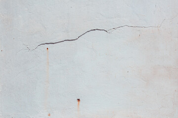 White brick wall with cracks, cement and blue plaster Can be used as a poster or background for design. 