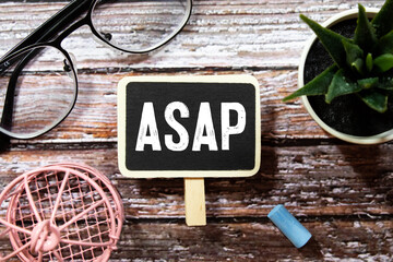 Alphabet letter in word ASAP Abbreviation of as soon as possible on wood background