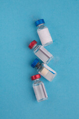 bottles with ampoules of vaccine on a light background