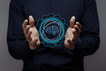 businessman holds a hologram of an artificial intelligence brain. concept of futuristic...