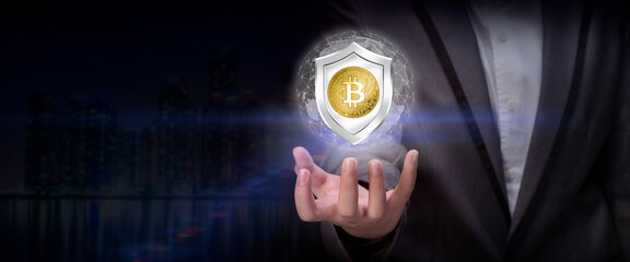 Businessman holding a shield with Currency sign on dark background, Concept of secure financial network, protection money.