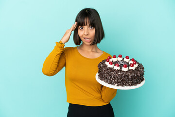 Young mixed race woman holding birthday cake has realized something and intending the solution