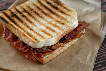 Close up of sandwich with grilled white bread and bacon