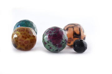 Different natural stone beads on a white background,Quartz agate stone beads,Many bracelets made of various natural stones,balls of natural mineral gemstones agate,