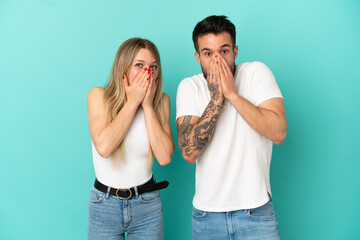 Young couple over isolated blue background with surprise facial expression