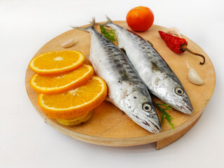 Fresh Seer Fish,King Fish decorated with herbs and vegetables on a wooden pad,Selective Focus.