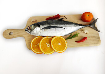Close up view of fresh Finletted Mackerel Fish or Torpedo Scad Fish decorated with herbs.White background,Selective focus.