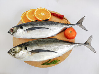 Close up view of fresh Finletted Mackerel Fish or Torpedo Scad Fish decorated with herbs.White background,Selective focus.