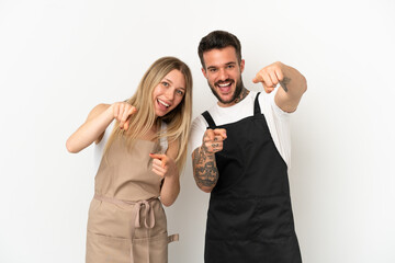 Restaurant waiter over isolated white background points finger at you while smiling