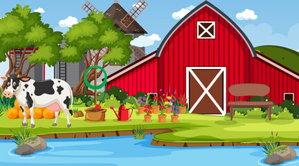 Red barn in farm scene with a cow