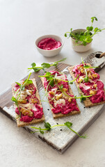 Dietary toasts with beetroot hummus, walnuts and parmesan cheese