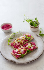 Dietary toasts with beetroot hummus, walnuts and parmesan cheese