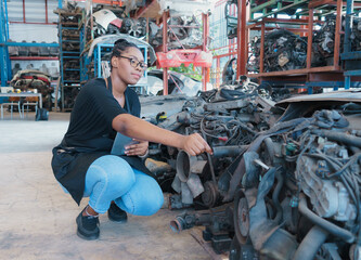 Woman working, pick auto part. Black African worker woman working and picking auto part in factory-warehouse