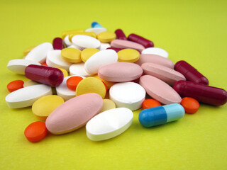   various pills on yellow background     