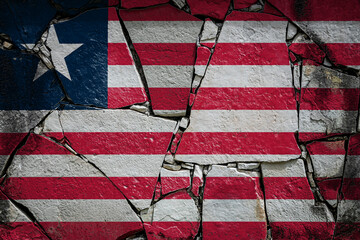National flag of  Liberia depicting in paint colors on an old stone wall. Flag  banner on broken  wall background.