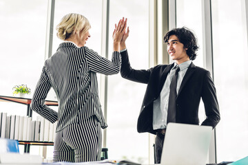 Successful of two business people giving hi five together