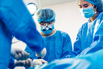 Professional anesthesiologist doctor medical team and assistant preparing patient to gynecological surgery performing operating with surgery equipment in modern hospital operation emergency room