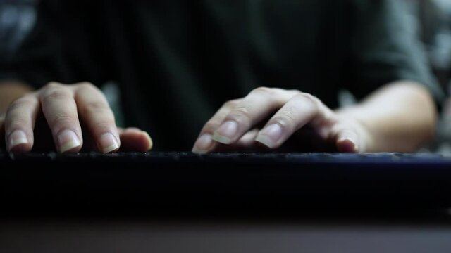 slow motion computer programmer man hand typing configuration on keyboard at laptop for input coding language to software for fix bug and defect of system in data center room , engineering and technol