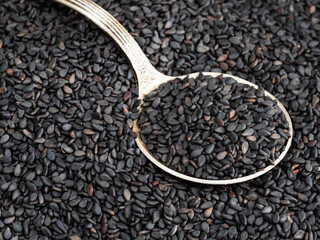 tablespoon in black sesame seeds close up
