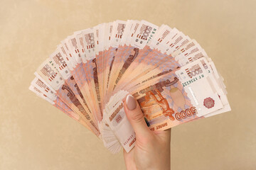 Woman hands holding stack of money