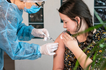 girl given injection in the shoulder. coronavirus vaccine.
Vaccination against coronavirus
