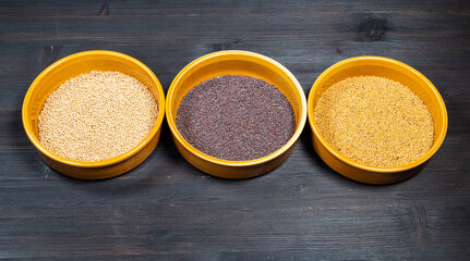 white, black, yellow mustard seeds in bowls