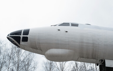 Front fuselage of a jet plane, outside against the sky. Combat Soviet aircraft, side view. Open-air aviation museum