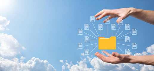 Document Management System DMS .Businessman hold folder and document icon.Software for archiving,...