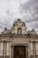beautiful classic colonial architecture style building facade with wooden door and dark gray sky