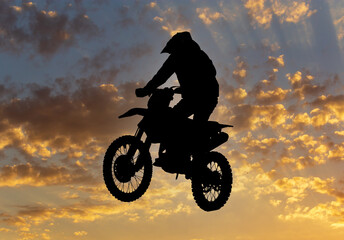Silhouette of a man on a motorcycle