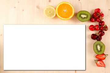 Top view mockup white blank sheet paper and Spring fruits on wooden background Mock up strawberry cherry kiwi grapefruit orange lemon fruit on table wood