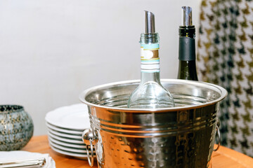 A table in a restaurant. Dinner with wine. Wine with a bucket of ice. Cold wine. Bottles of wine.