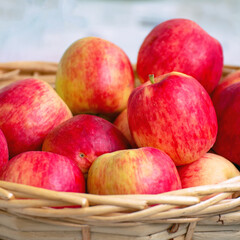 Red ripe apples in a wicker basket