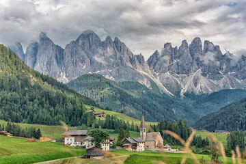 Fototapeta na wymiar Santa Maddalena village with beautiful Dolomites mountains in the background, Val di Funes valley, Italy