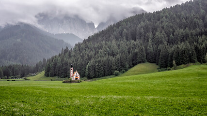 Fototapeta na wymiar The scenery of the Dolomites with the St. John's in Ranui Chapel in Santa Maddalena. Italy
