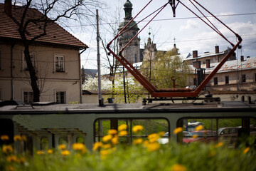 Yellow tram in the old city of Lviv against the backdrop of the Bernardine Cathedral