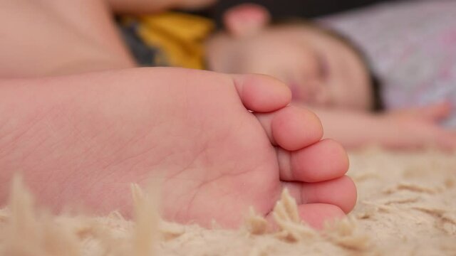 Close-up of the foot of a boy sleeping on a bed