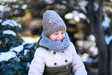 teen girl posing in winter forest, playing with snow