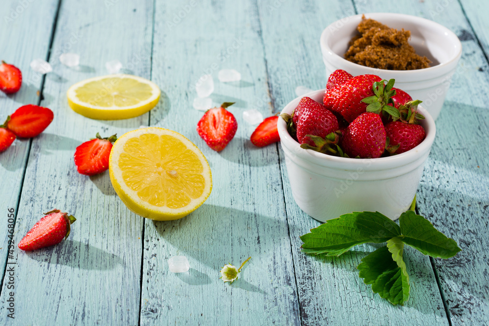 Sticker strawberry jam ingredients on blue wooden table