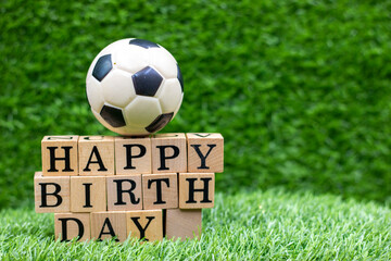 Soccer birthday with ball and Happy Birthday on green grass