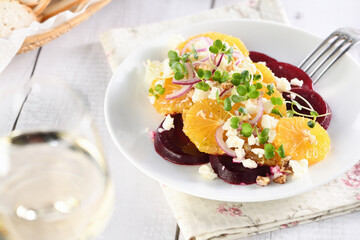 Orange salad with baked beetroot, goat cheese, microgreens and nuts. Perfect as a side dish or as a light lunch for a brunch or dinner.