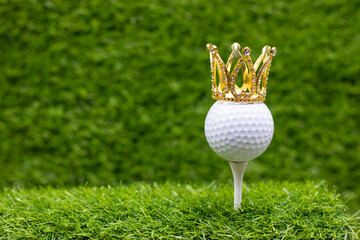 Golf ball with golden diamond crown on green grass