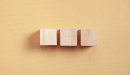 Wooden cubes on yellow background.