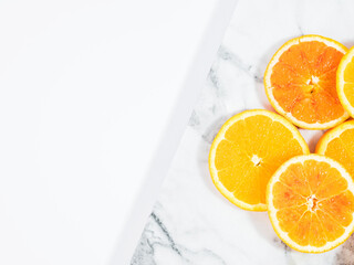 Colorful orange citrus slice fruit texture background on white marble table