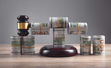 Judge gavel and money rolls on wooden table.