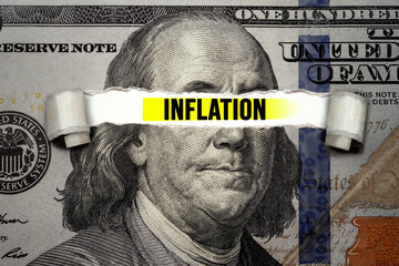 Torn bills revealing Inflation words. Idea for FED consider interest rate hike, world economics and...
