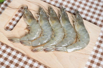 fresh shrimps on wooden cutting board plate. fresh shrimp prawns for cooking