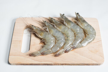 fresh shrimps on wooden cutting board plate. fresh shrimp prawns for cooking