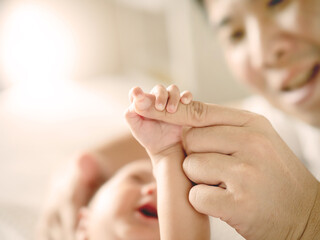  Baby hand holding finger of  her Dad , Father's day or happy family concept